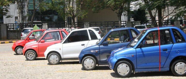 A row of small cars in a parking lot.