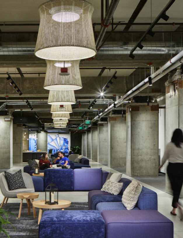 a large lobby setting with couches and a long walkway