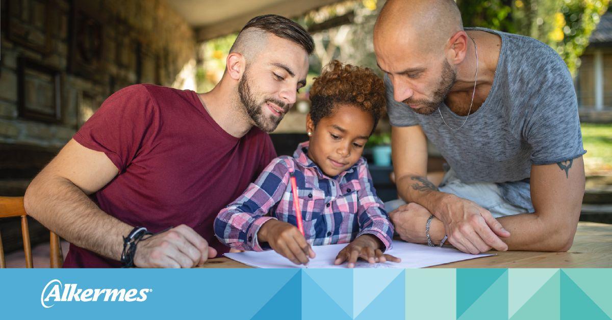 family with a child writing and the Alkermes logo