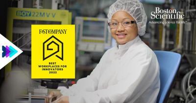 a person seated in lab protective gear, monitors and equipment behind them. "Fast Company" award logo and Boston Scientific logo in upper right corner