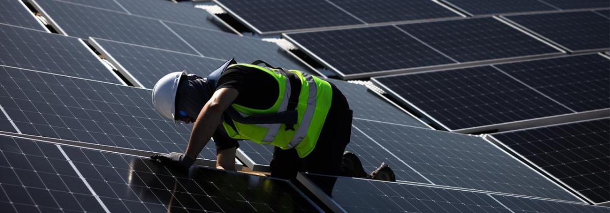 Worker installing polar panels  