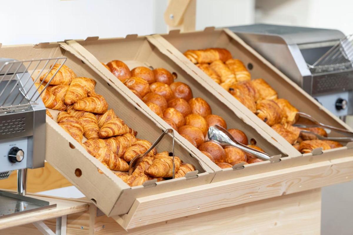 Boxes of different breads and serving utensils.