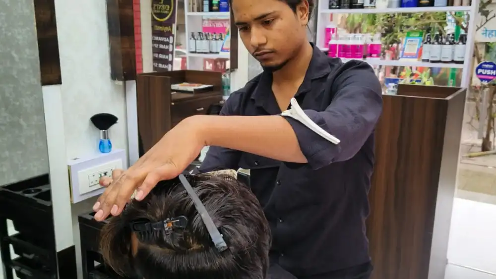 A hairstylist working on a client's hair