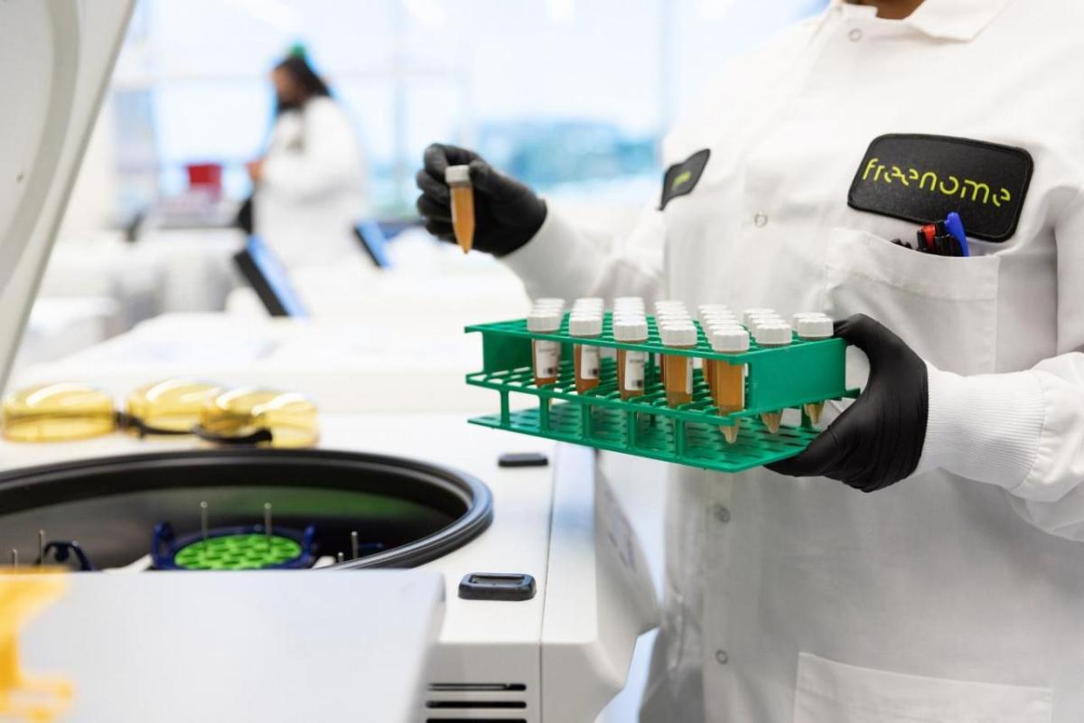 scientist holding tray of vials