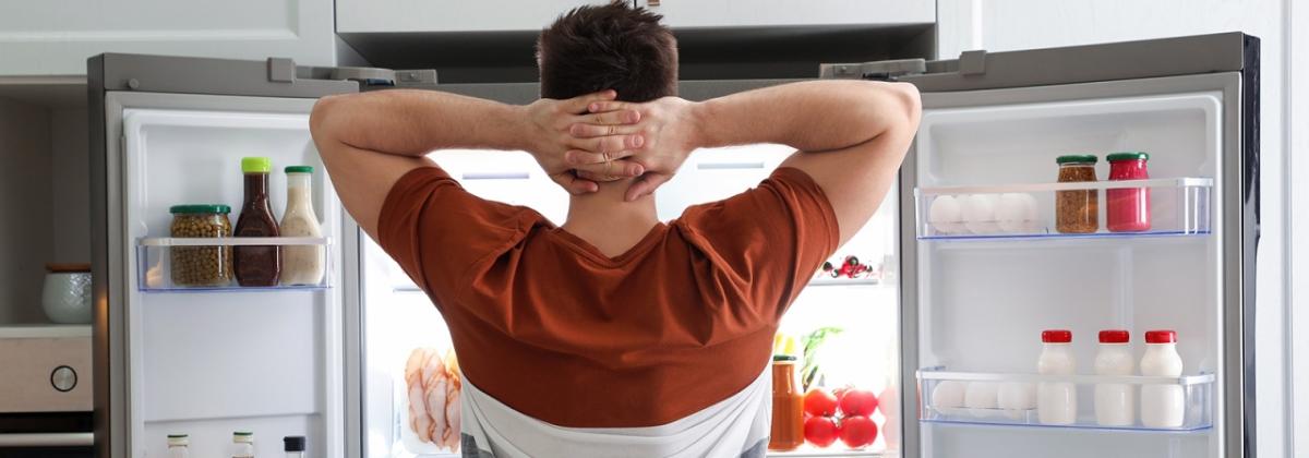 Person in front of open fridge