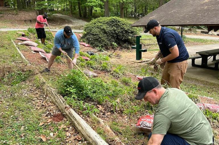 A group of volunteers doing landscaping.