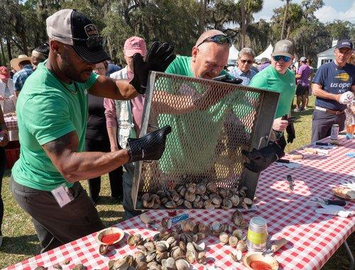 People dropping oysters onto a table