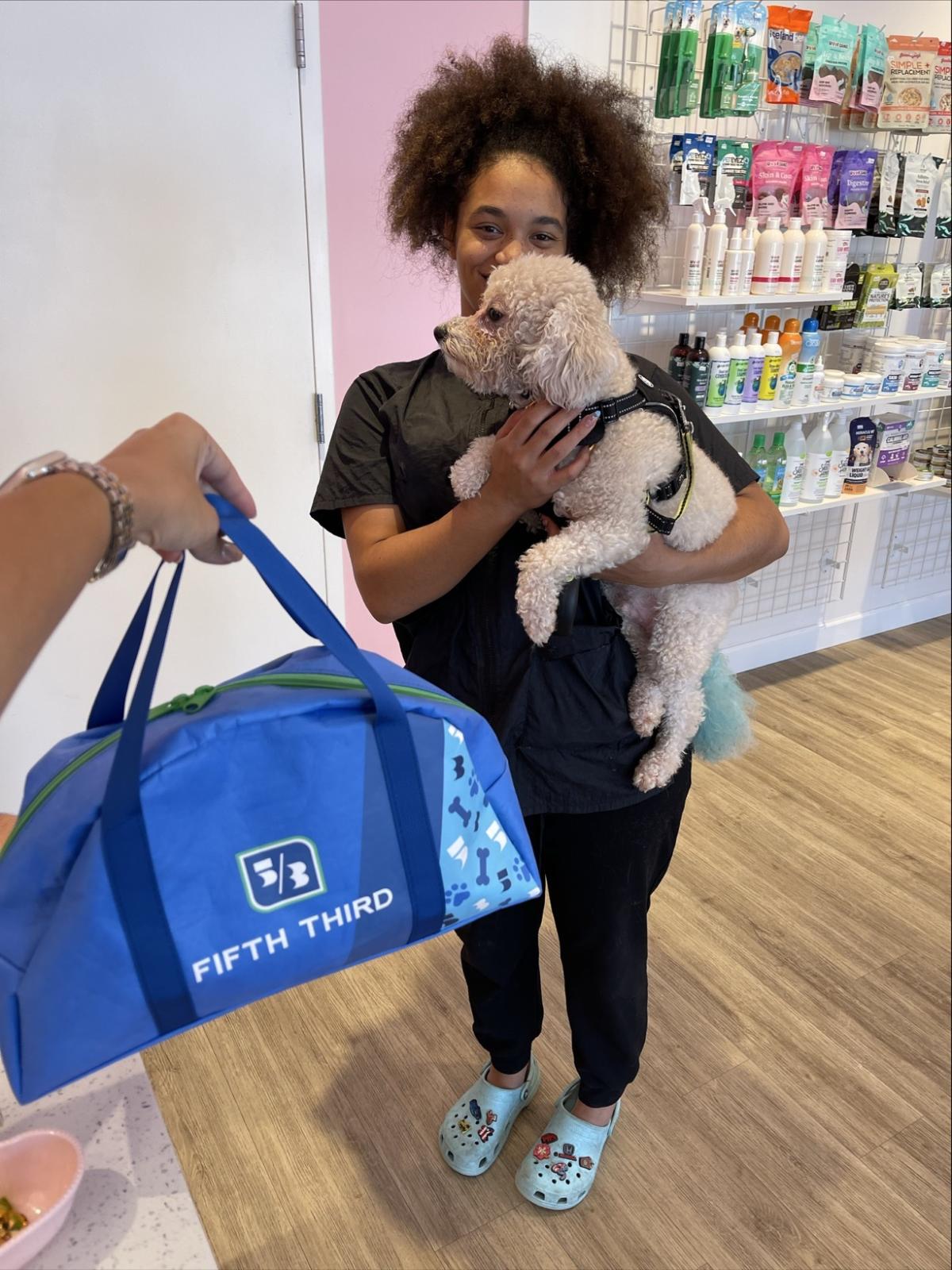 A pet owner holding their dog