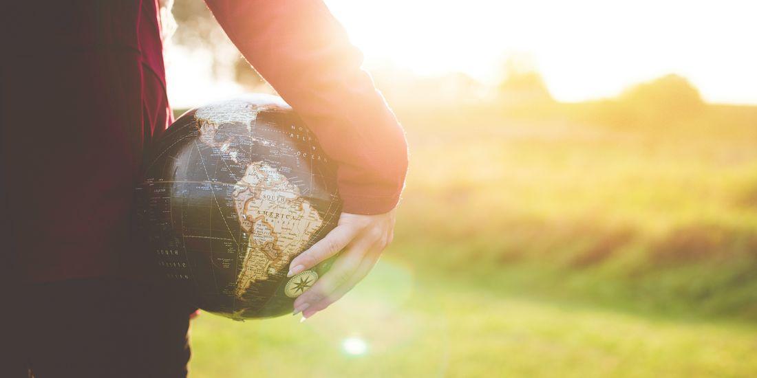 A person holding a globe 