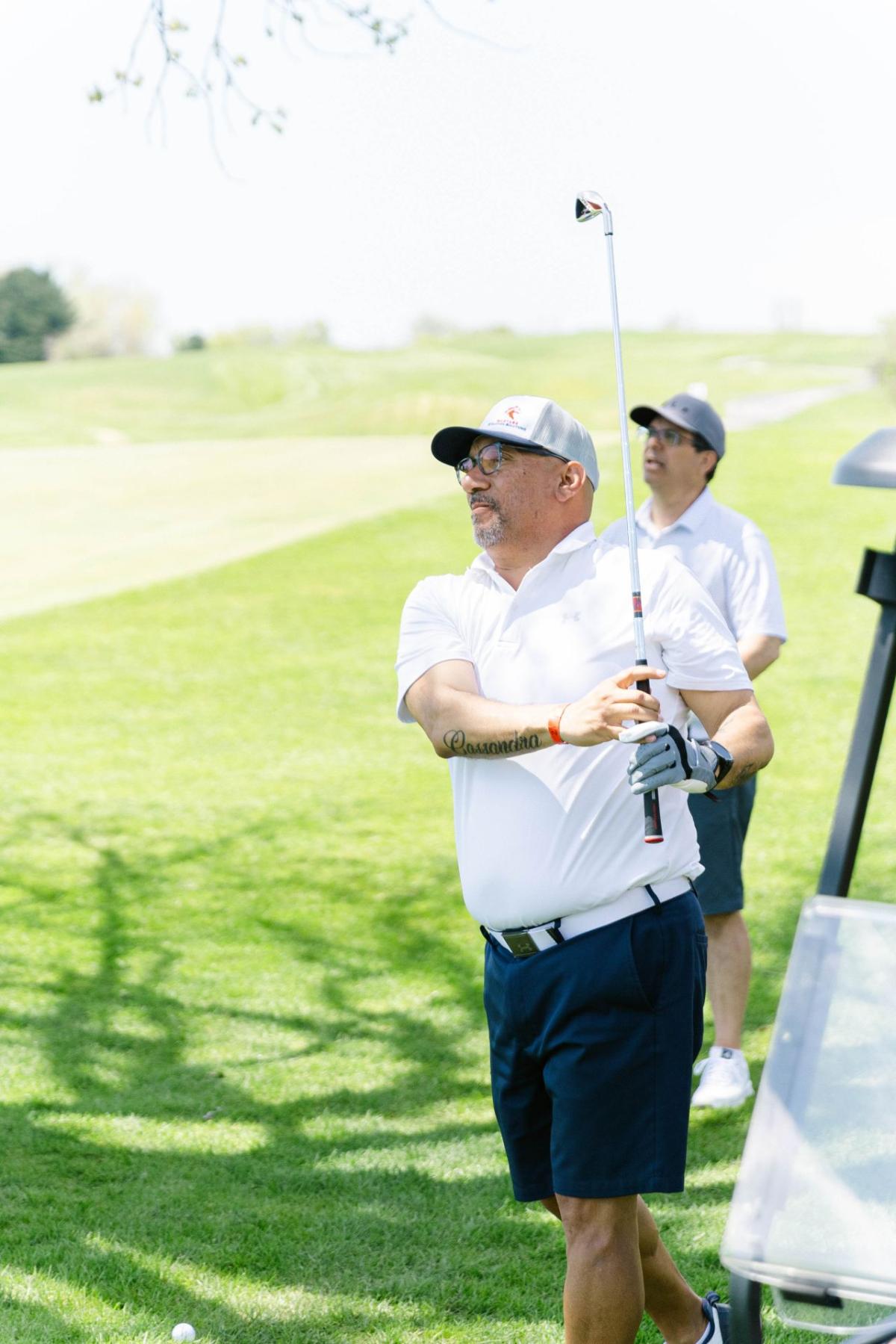 Two people golfing.