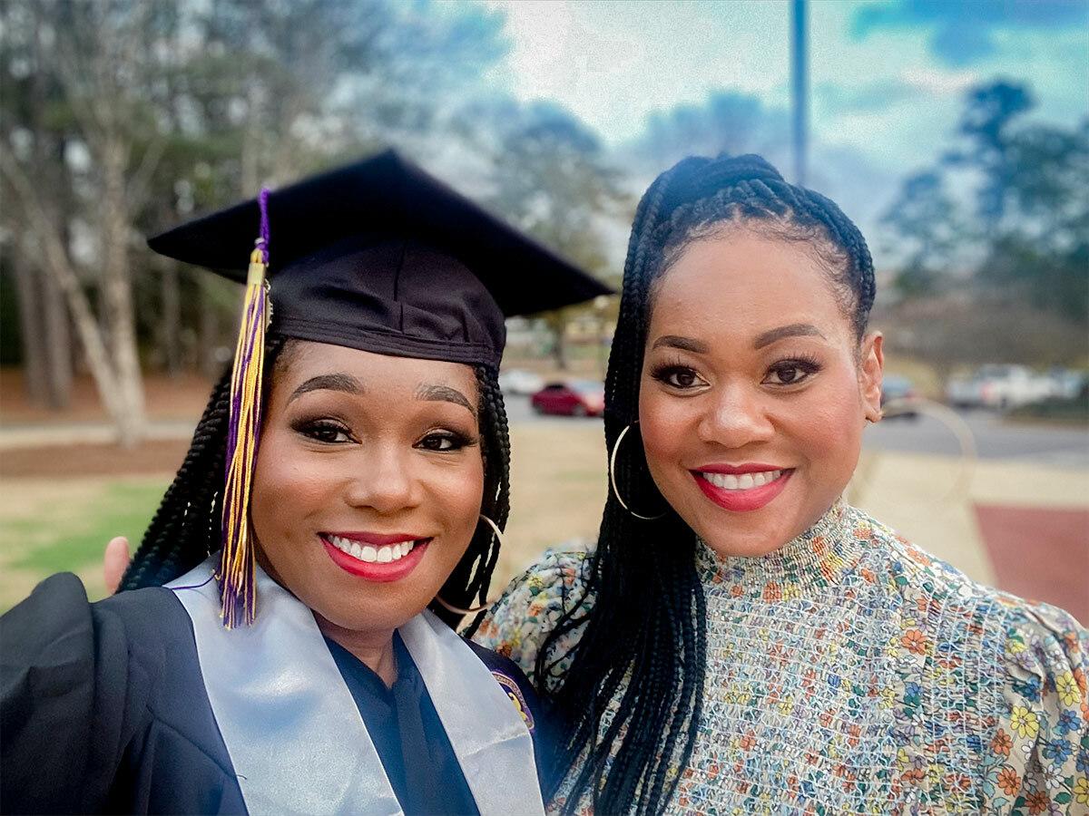 Floresha and another in graduation cap and gown