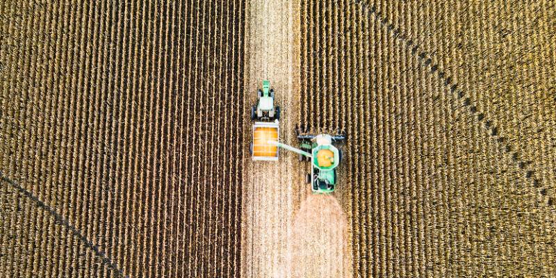 Aerial view of farm machinery gathering crops.