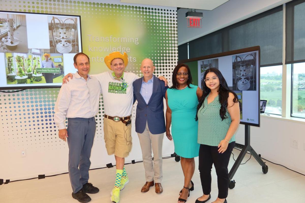 Employees and volunteers posed in a room with displays from "Green Bronx Machine"