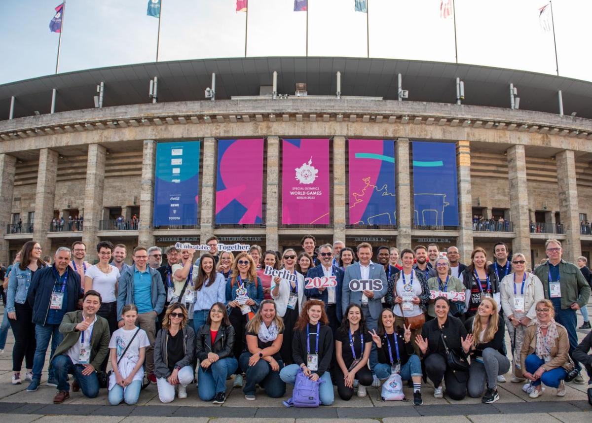 Otis volunteer team in front of stadium