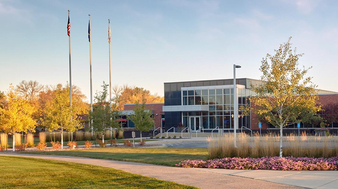 Exterior view of Hormel headquarters, three flag poles in front.