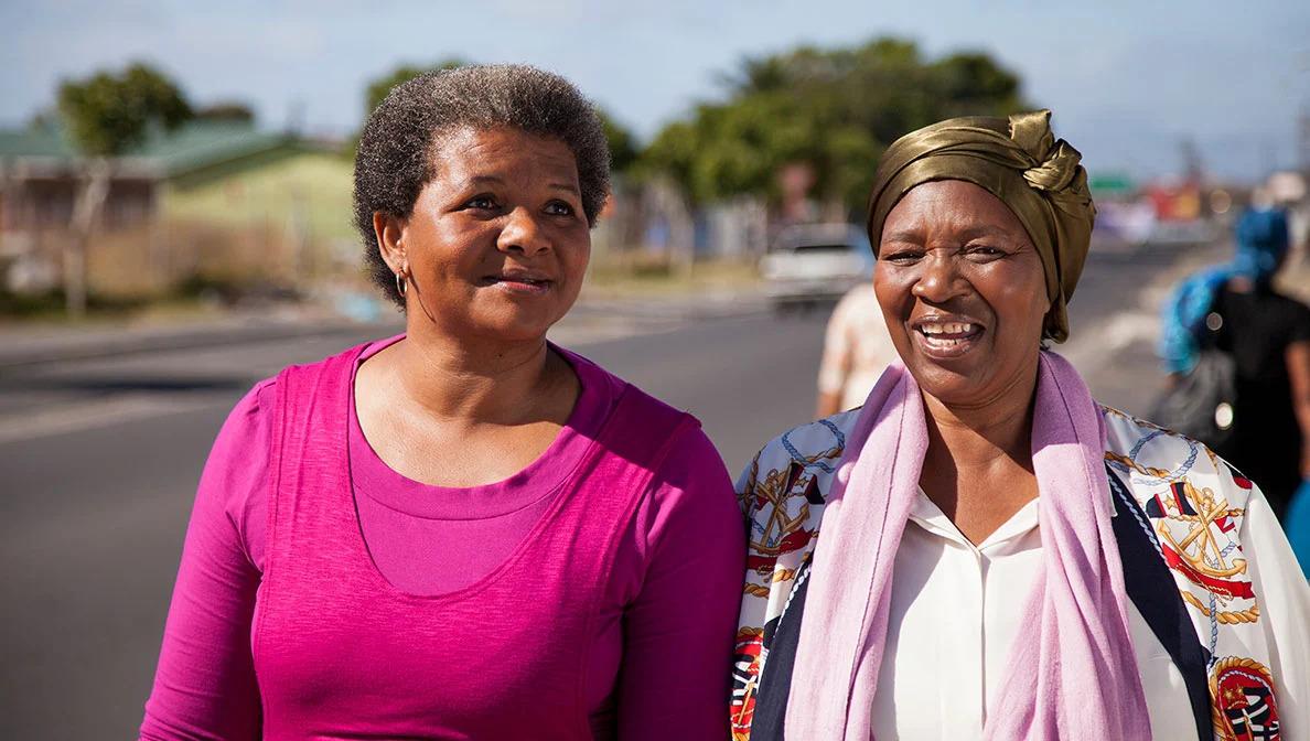 two people walking beside a street