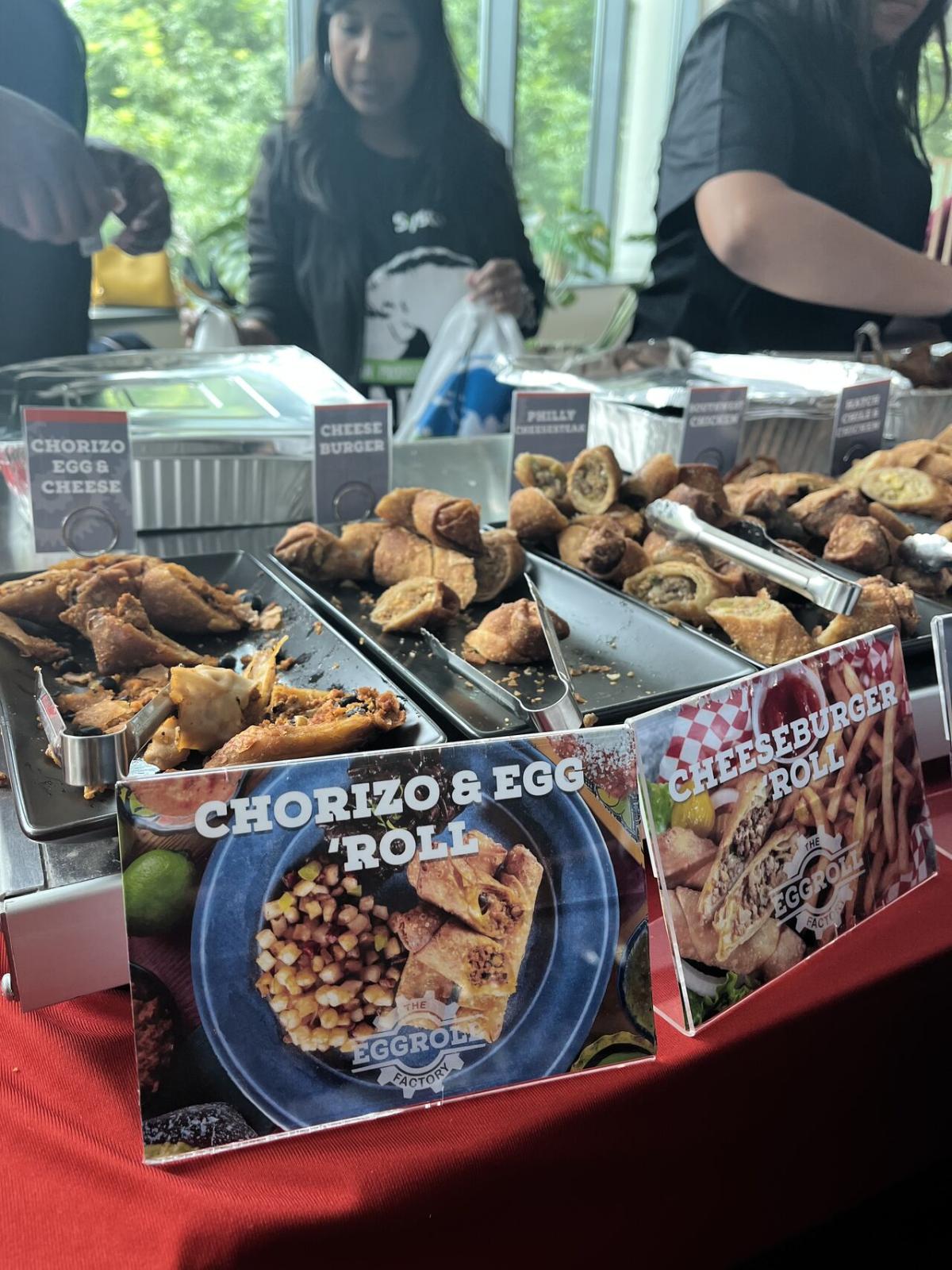 Various foods in metal trays on a table