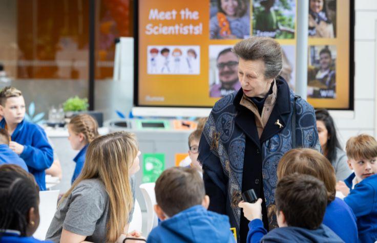 HRH Anne shown with children on DNA Day.