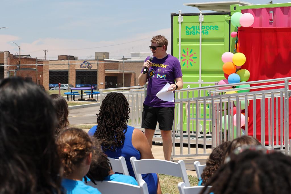 Jeffrey Whitford speaking to an audience in front of the Curiosity Cube.