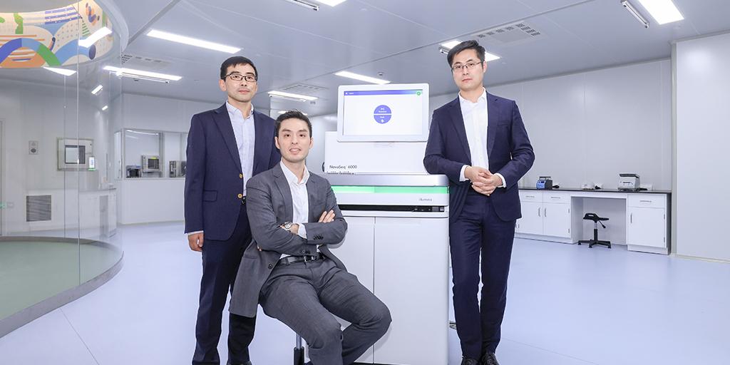 Illumina scientists in front of a computer screen.