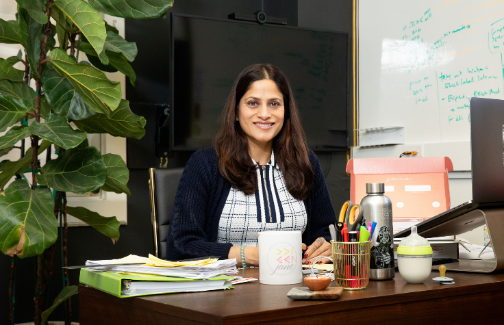 Ridhi Tariyal seated at a desk smiling.