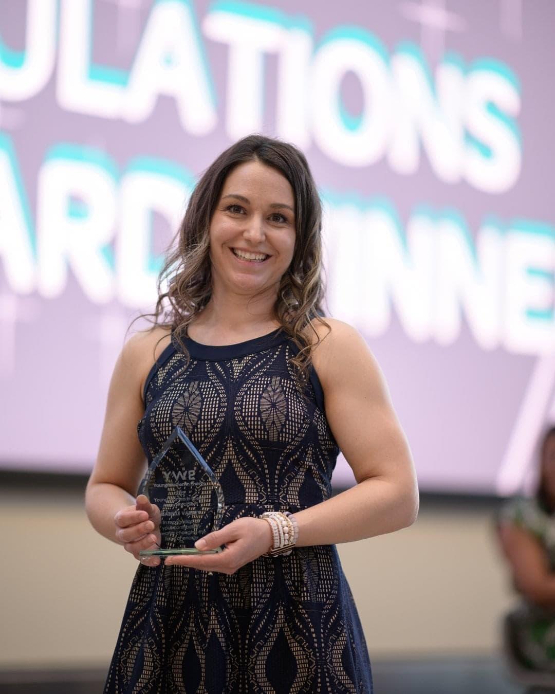 Isabelle Varney holding an award.