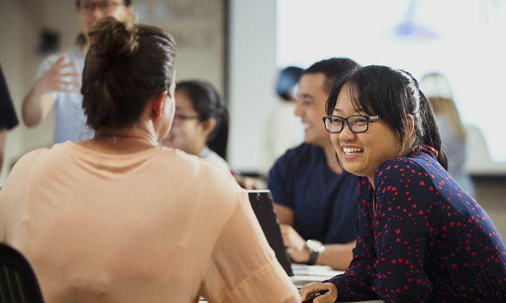 group of people talking and smiling