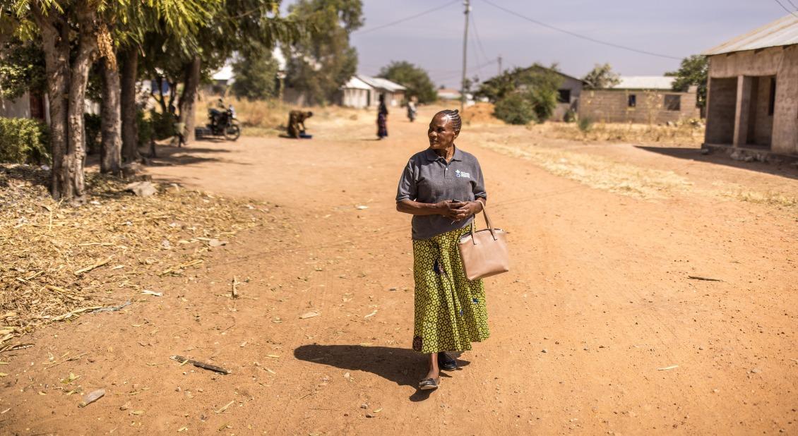 Janet walks from home to home to check on mothers and children.