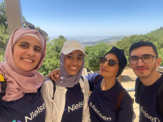 Four people take group selfie 