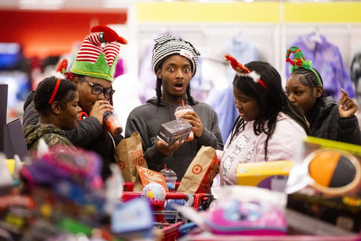 Kids gathered around a table of toys, one is very surprised.