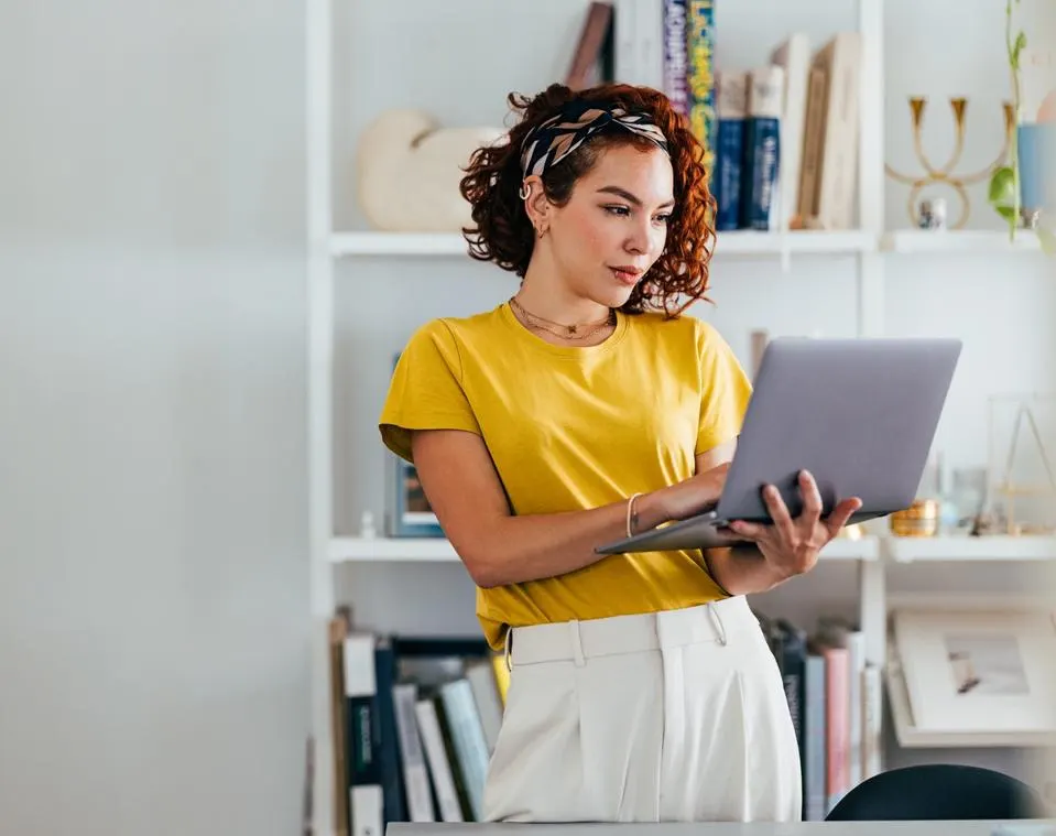 Person using laptop while standing 