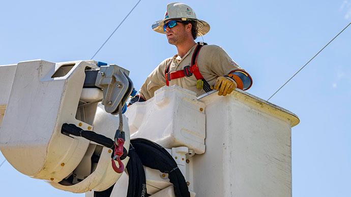 A line-worker in a bucket-lift near power lines