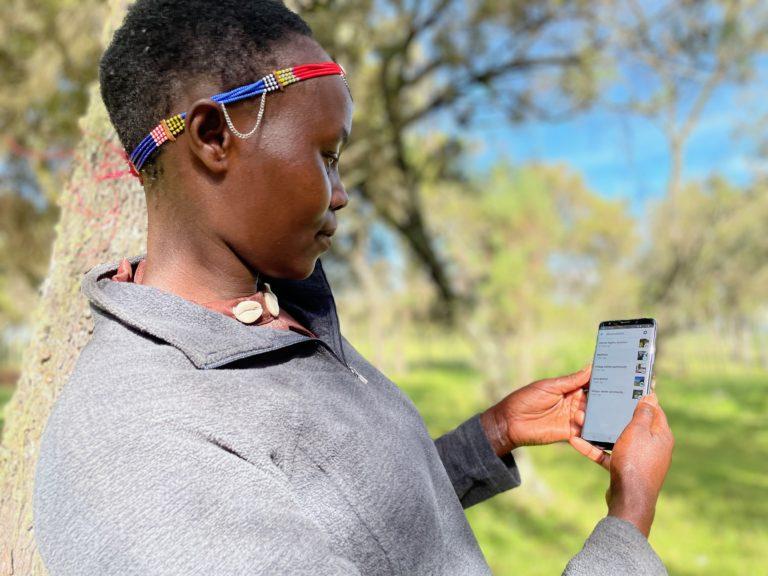 Leah, a member of the Ogiek community of Mt. Elgon, using Mapeo. Photo Credit: Awana Digital. " "