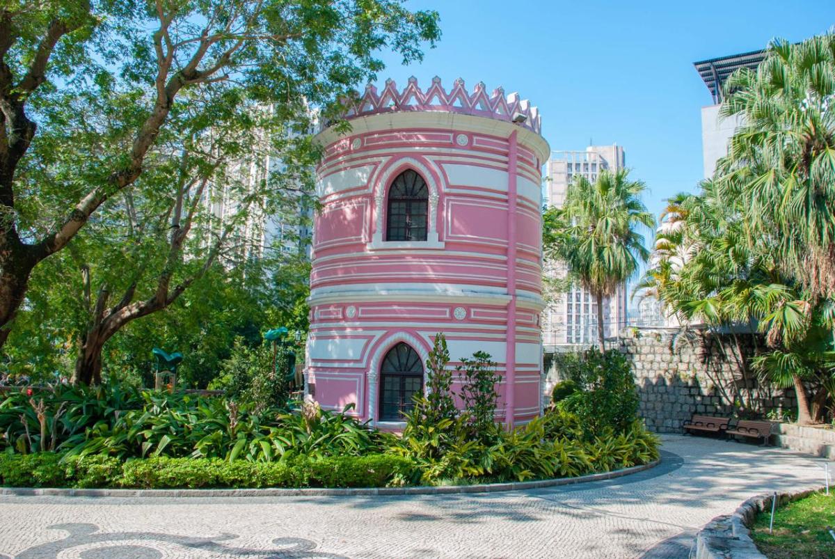 A round structure in a park setting, colorfully painted.