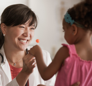 Doctor giving a child a lollipop 