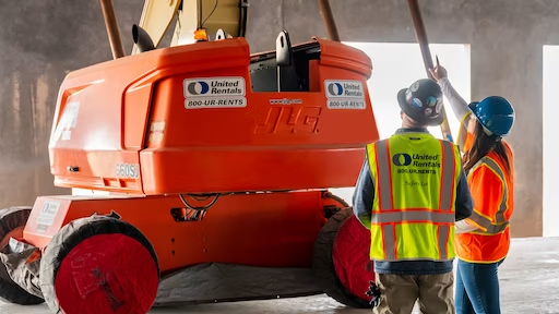 United rentals machine with workers standing in front of it