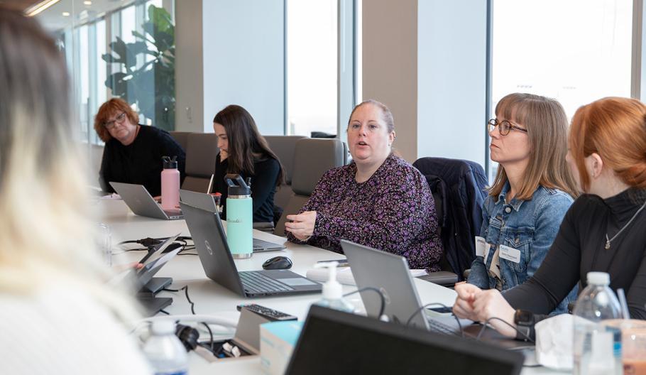 6 people pictured at a meeting