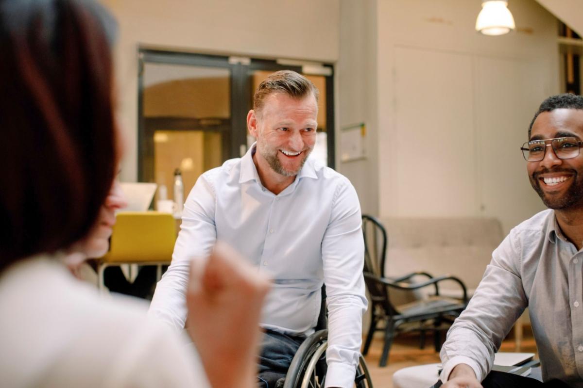 Person laughing with two others