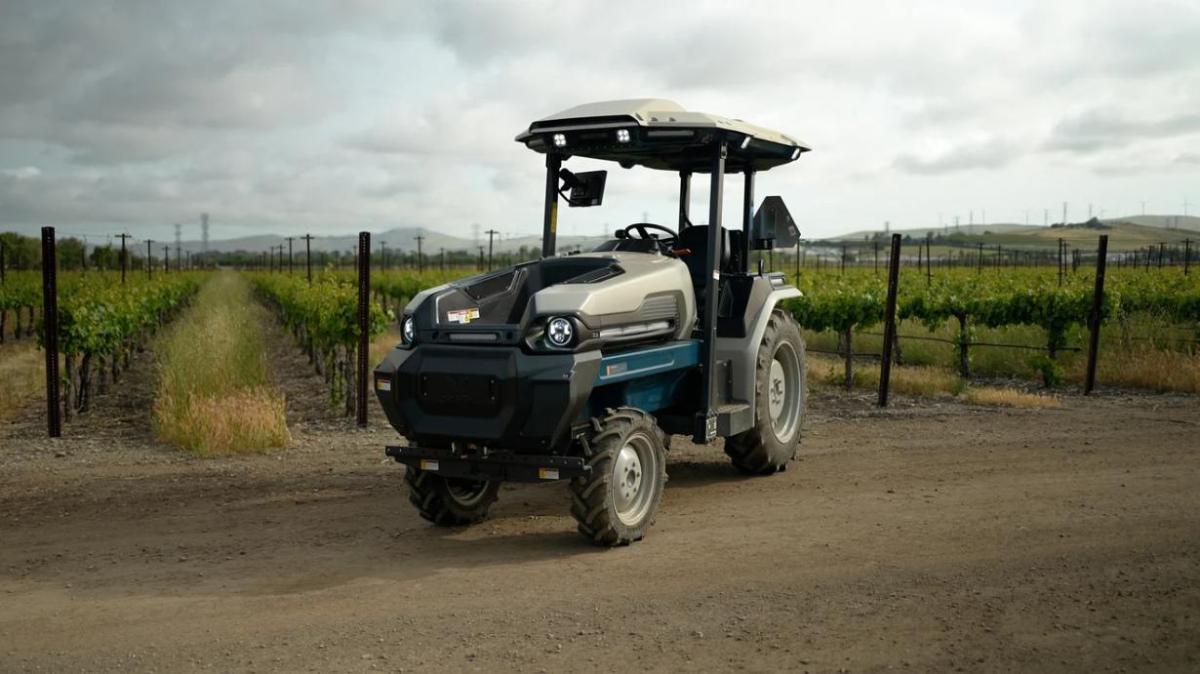 Tractor in front of a crop