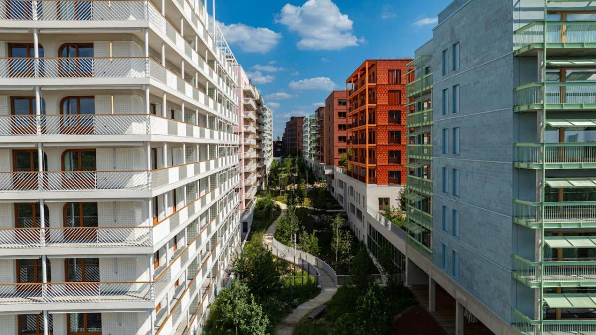 Aerial view of a courtyard between tall residential complexes.