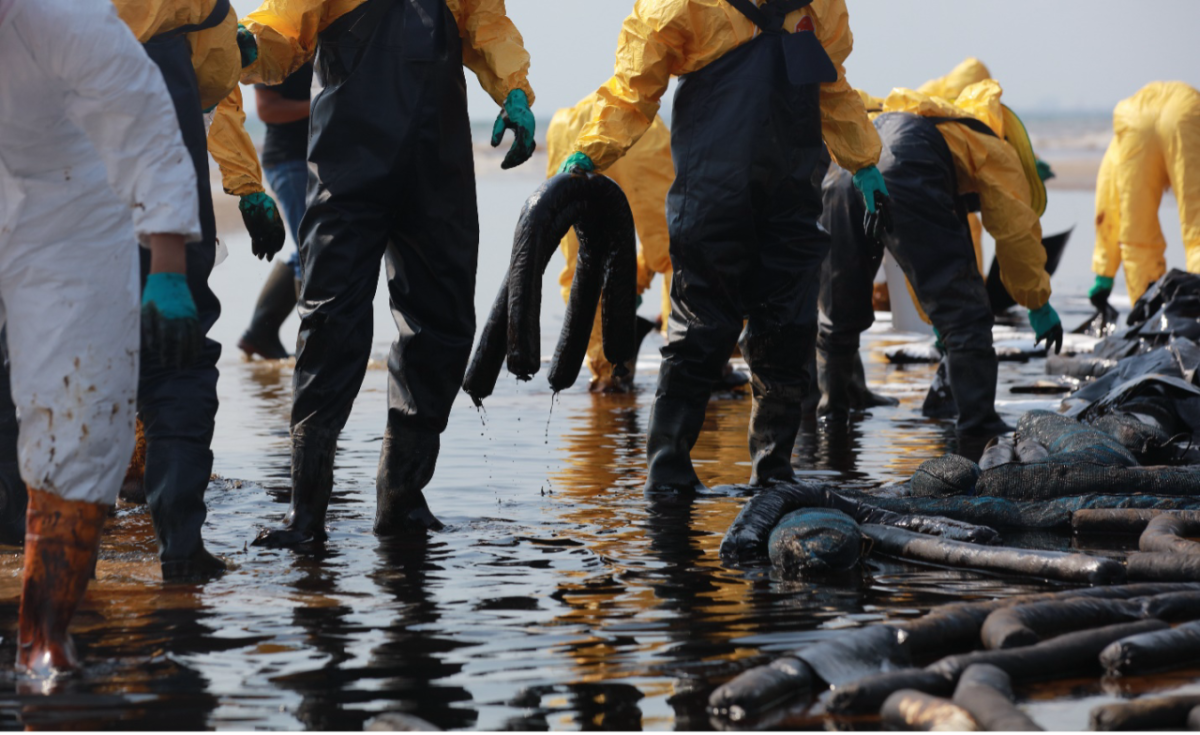 People in waders cleaning up debris in a body of water