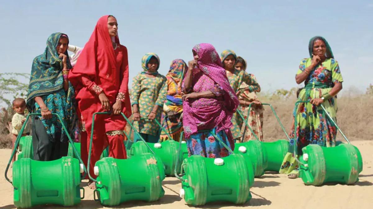 a group of people each with a large green water jug