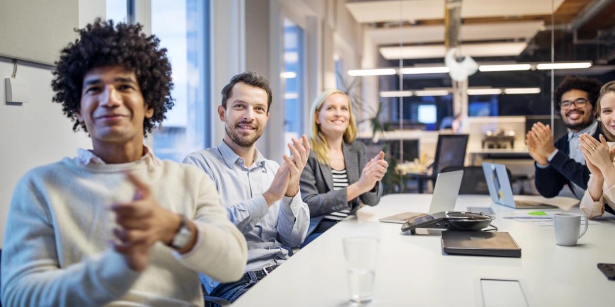 people clapping at a meeting