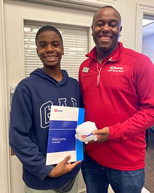 'Ella the Banker' author Liam Okolloh, left with branch manager Ramone Davis.
