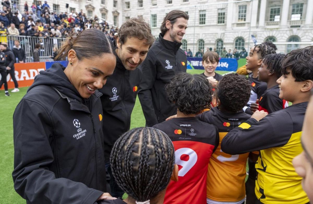 Children and adults gathered on a soccer field.