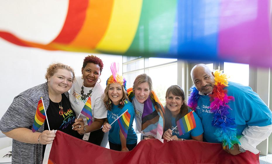 DeAnna Lowe, Cicely Hart, Kristie McKillip, Susan Wilde, Julie Orben and Harley McCorkle with pride flags