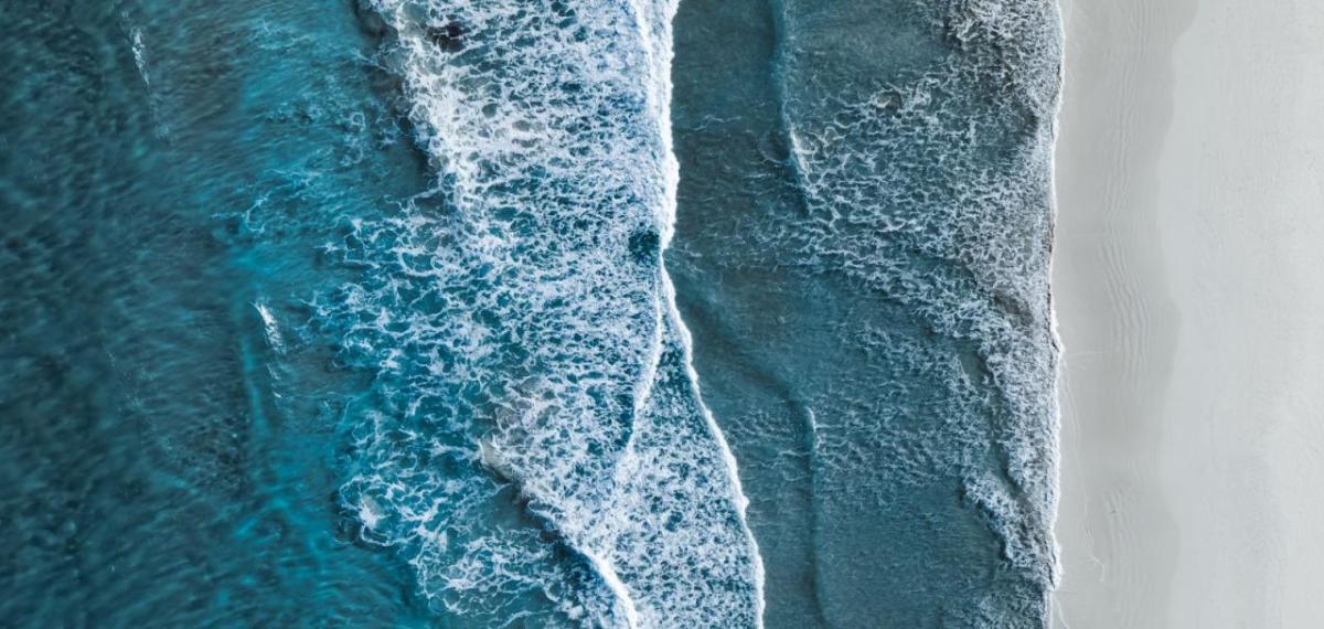 Aerial view of waves against a shoreline