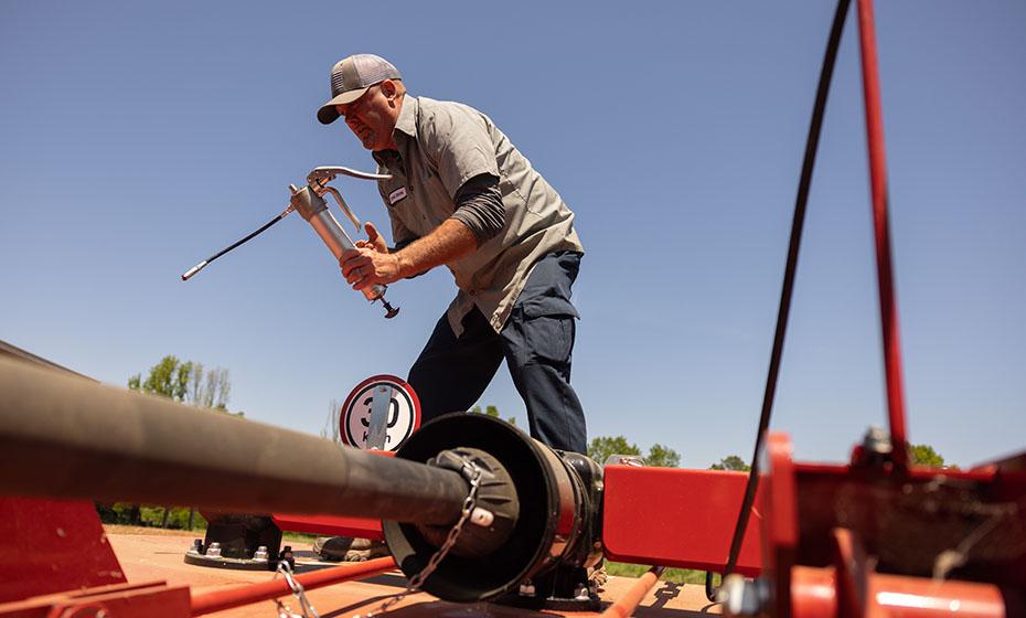 Michael Dalton repairing farm machinery