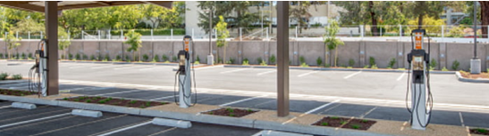 A parking lot with multiple EV charging stations.