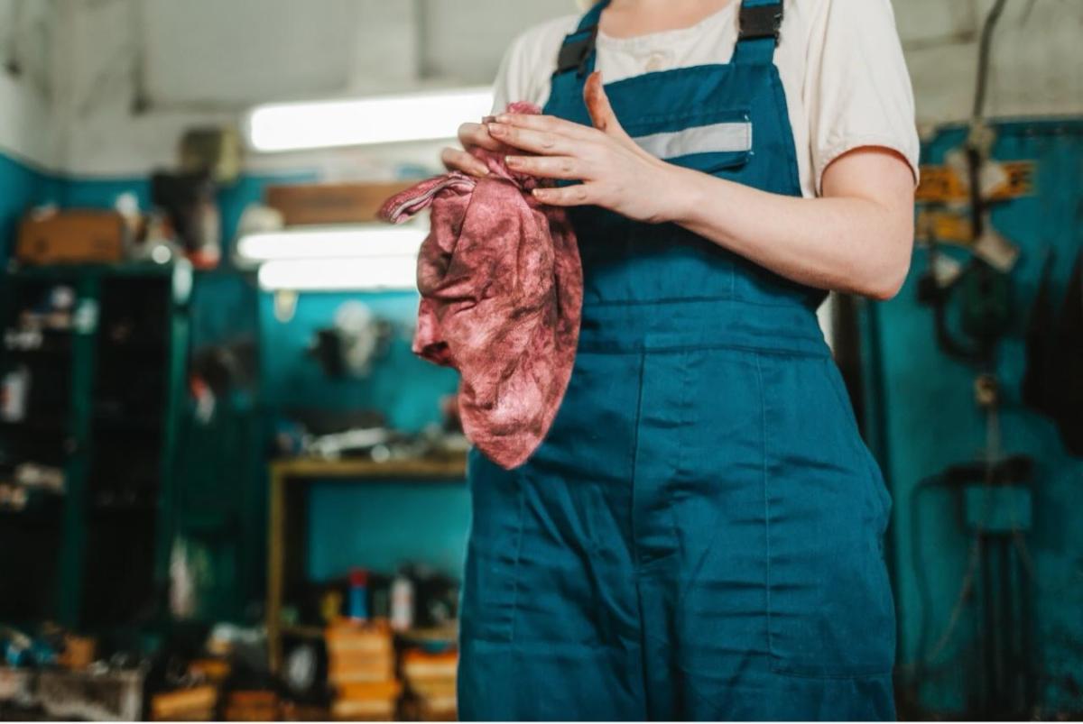 person cleaning their hands in a shop